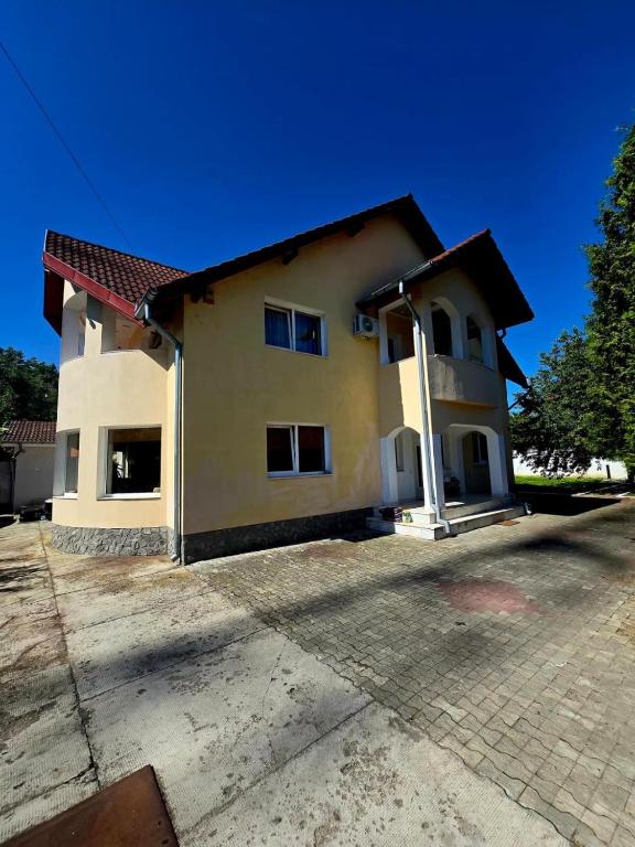 a house with a driveway in front of it at Casa Elena in Râmnicu Vâlcea