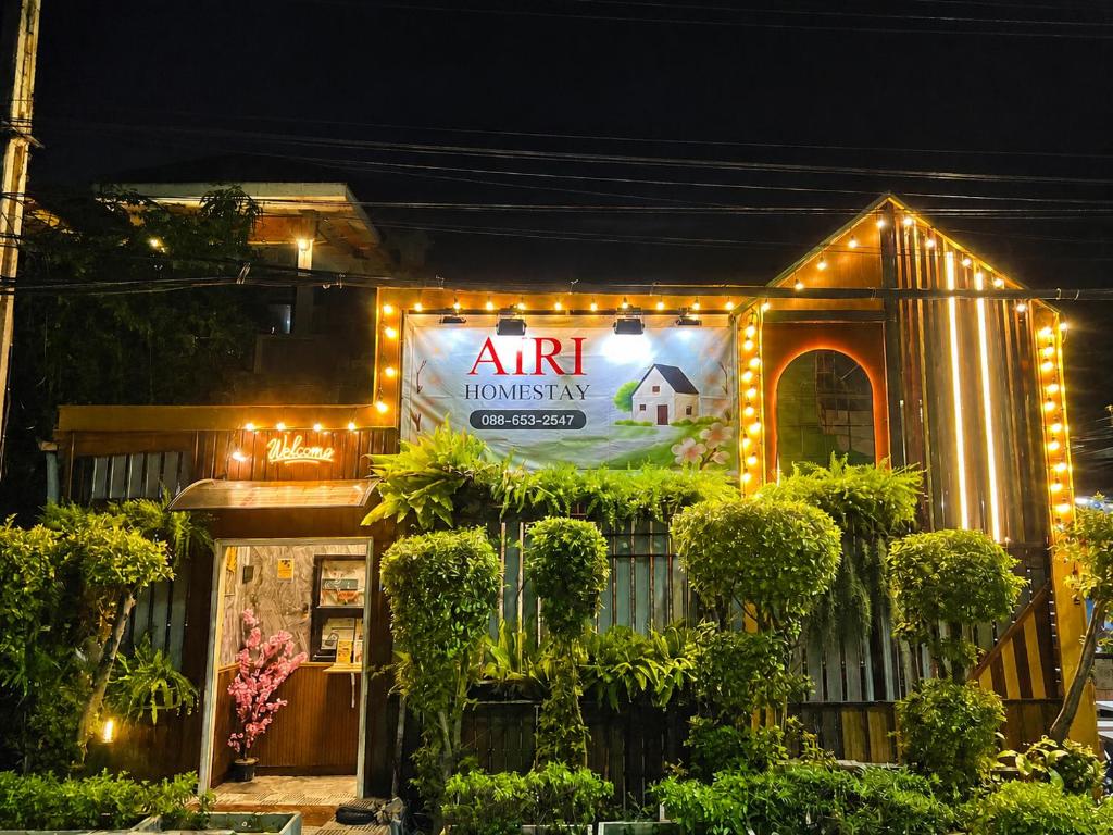 a sign on the side of a building with lights at Airi Homestay in Suvarnabhumi Airport