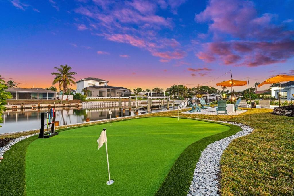 a golf course with a putting green and a golf ball at Casa Azul - Waterfront Villa with Pool & Dock in Marco Island