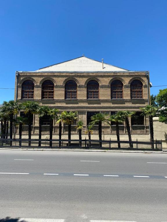 a building with a fence in front of a street at Heritage Garden Villa by Eldar in Ganja