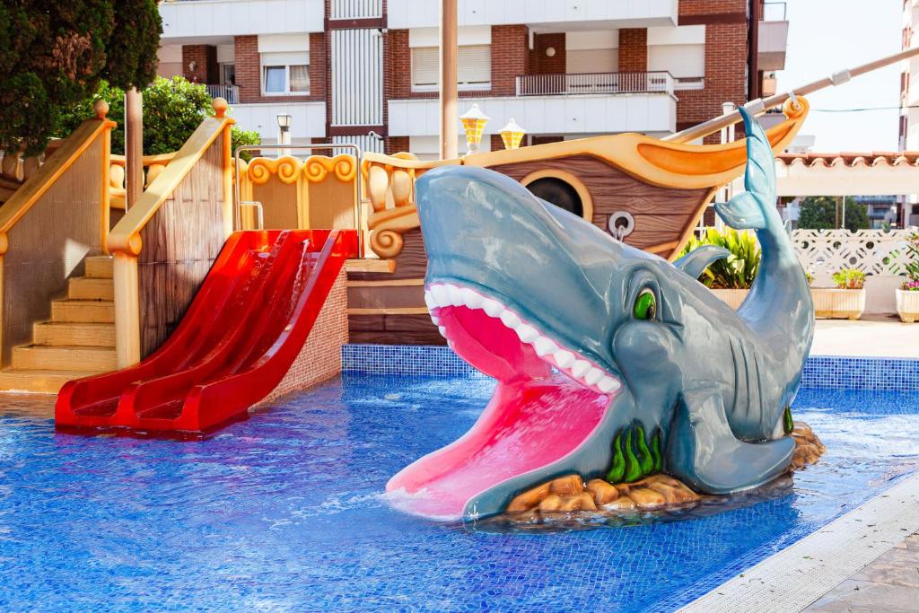 a slide in a water park with a shark on it at Hotel Bon Repos in Calella