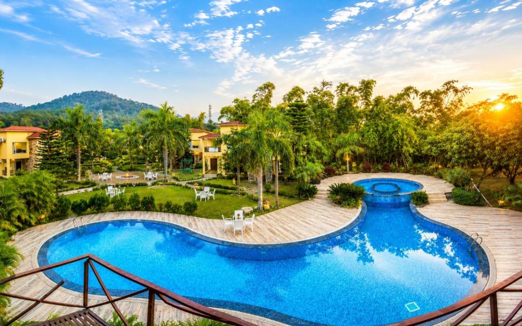 an image of a swimming pool at a resort at Mango Bloom River Resort By Excel Hotels & Resorts in Marchula
