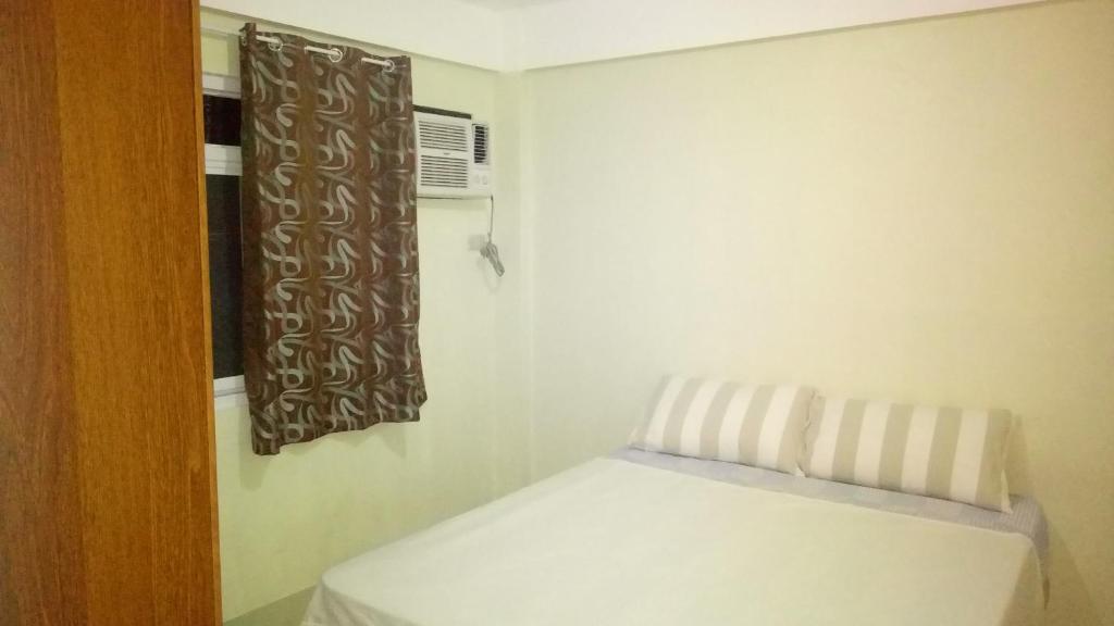 Postel nebo postele na pokoji v ubytování San Juan La Union Apartments