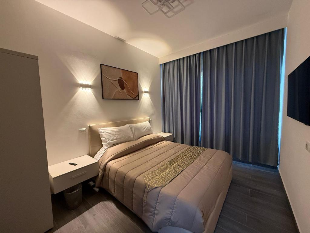 a hotel room with a bed and a window at Residence Meraviglia in Schio
