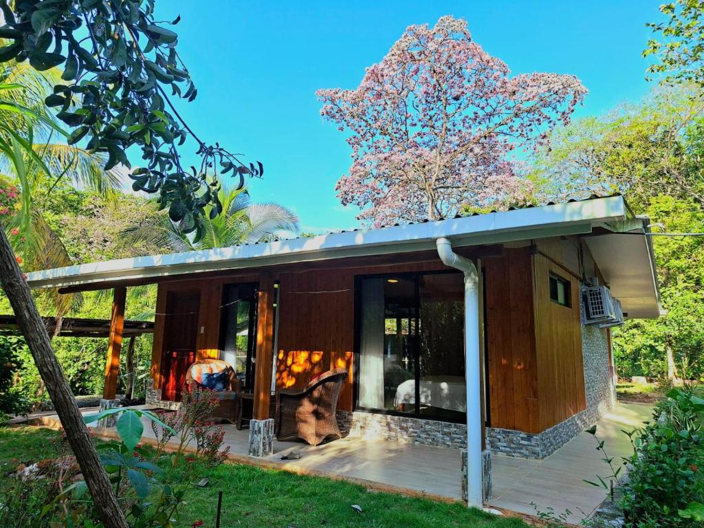 a small house with a large glass door at House in Playa Carrillo-Samara in Arbolito