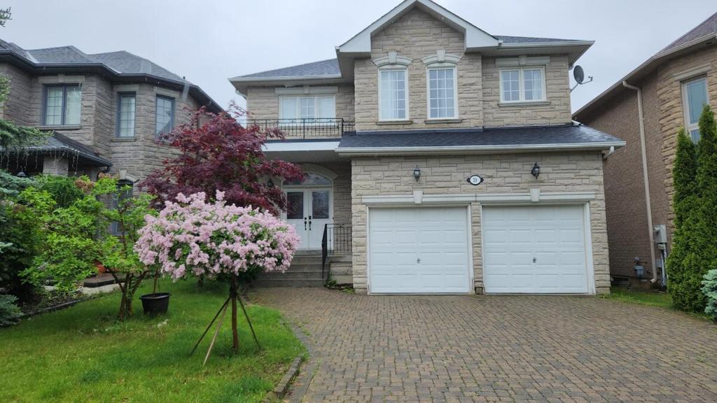 a house with a white garage in the driveway at Harmony House in Richmond Hill