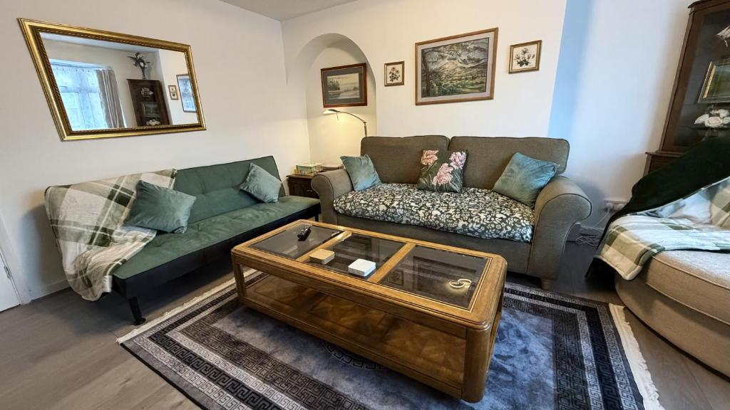 a living room with a couch and a coffee table at Peake Edge Home in Chesterfield