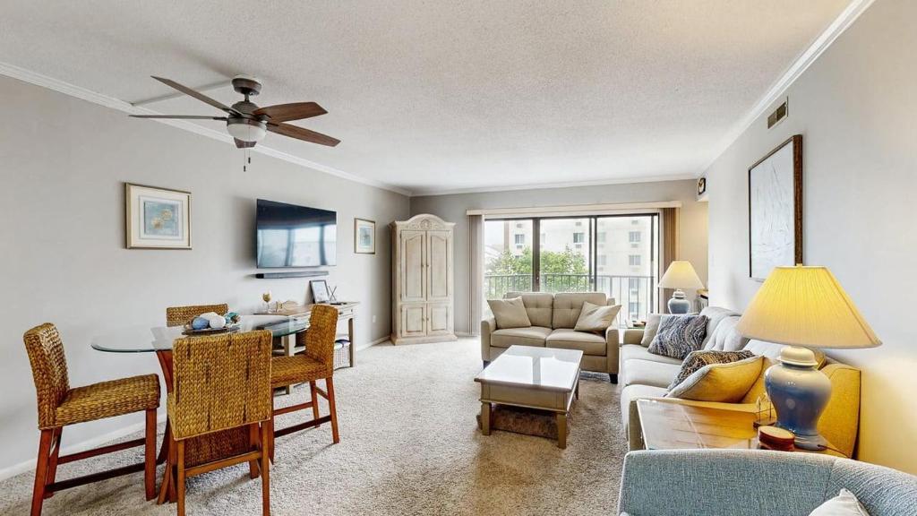 a living room with a couch and a table at Ocean Block retreat with easy beach access & shared pools in Ocean City