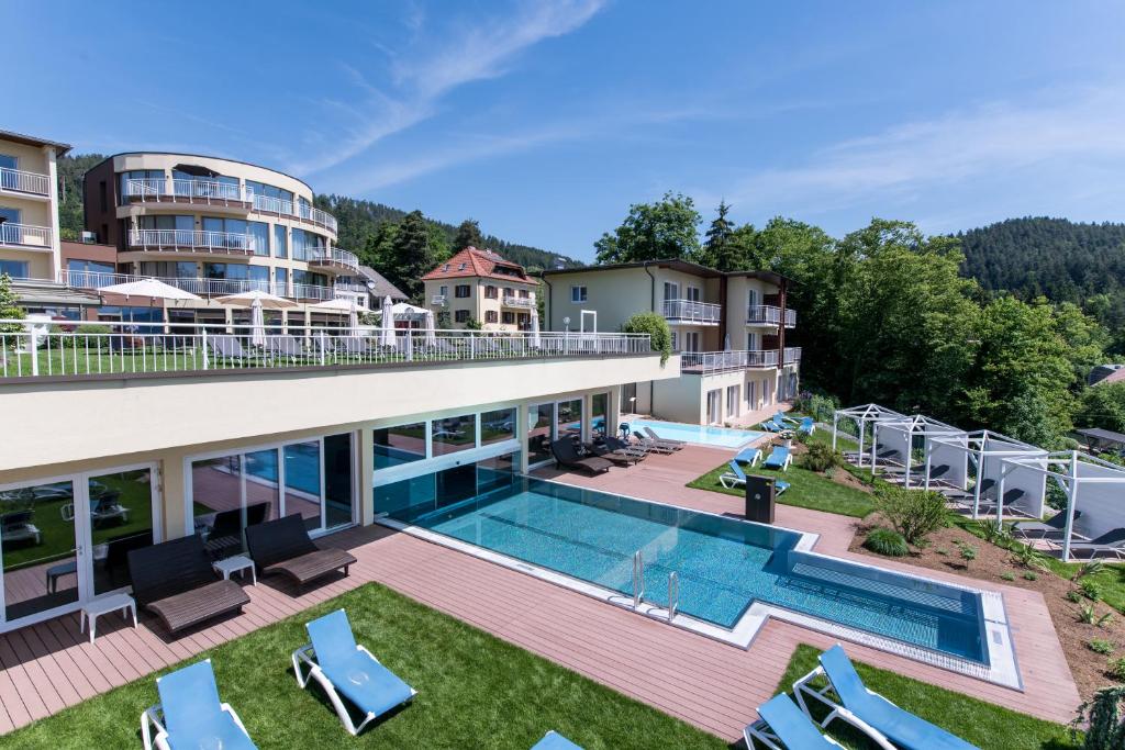 an aerial view of a resort with a swimming pool at das Balance - Spa & Golf Hotel am Wörthersee in Pörtschach am Wörthersee