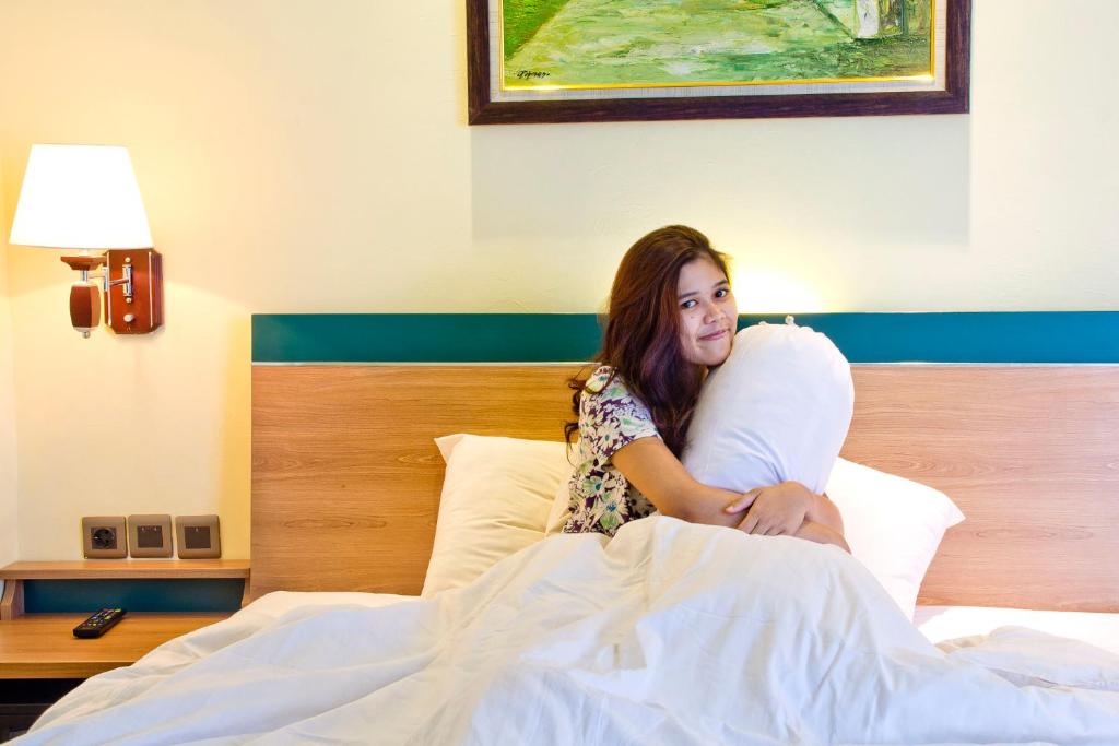 Postel nebo postele na pokoji v ubytování Green Batara Hotel