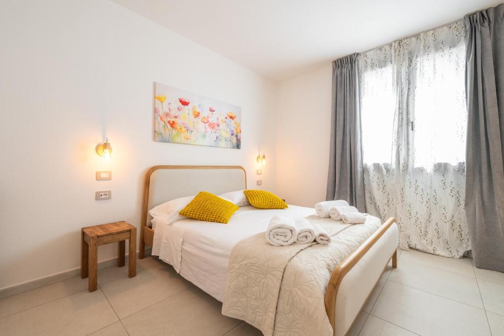 a bedroom with a bed with towels on it at Domus Soli in Teulada