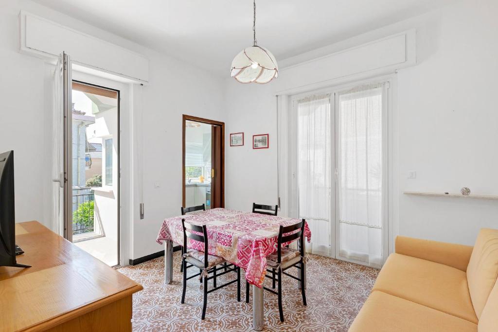a dining room with a table and chairs at Isonzo Holiday Home - 2 bedrooms in Loano