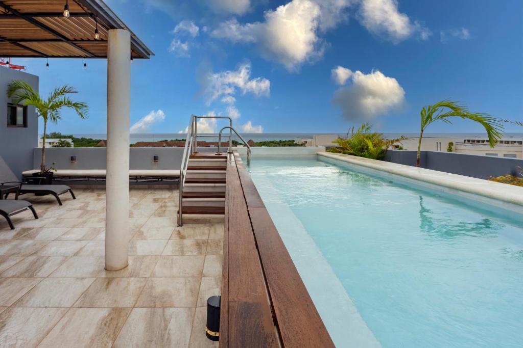 a swimming pool with a stairway leading to a resort at Casa Bonita Boutique Stay Near Beach in Playa del Carmen