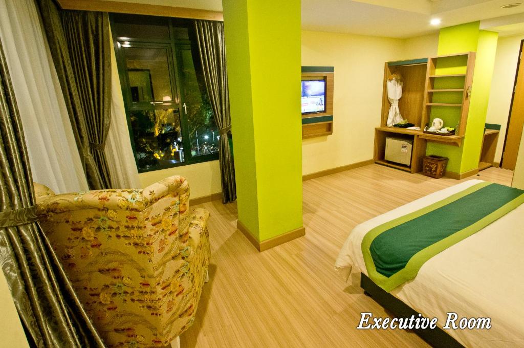 Postel nebo postele na pokoji v ubytování Green Batara Hotel