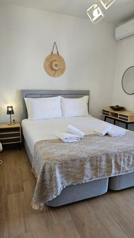 a bedroom with a bed with two towels on it at Athinais Karystos in Karistos