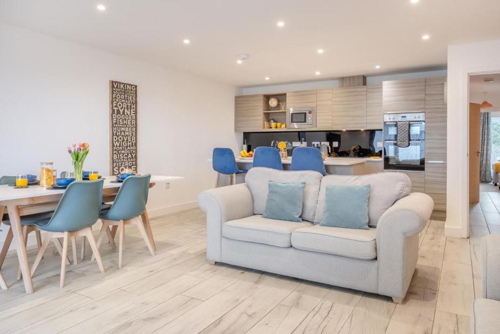 a living room with a couch and a dining room at 2 Bed in Sandown oc-90013 in Sandown