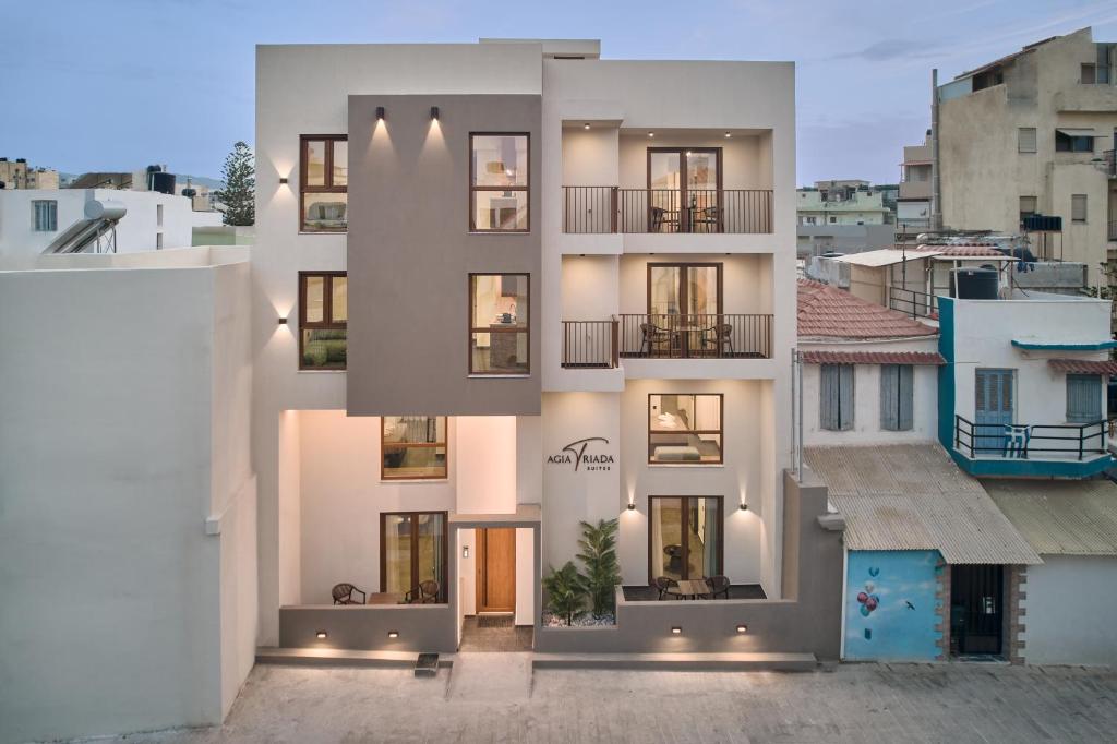 a large white building with many windows at Agia Triada Suites in Heraklio