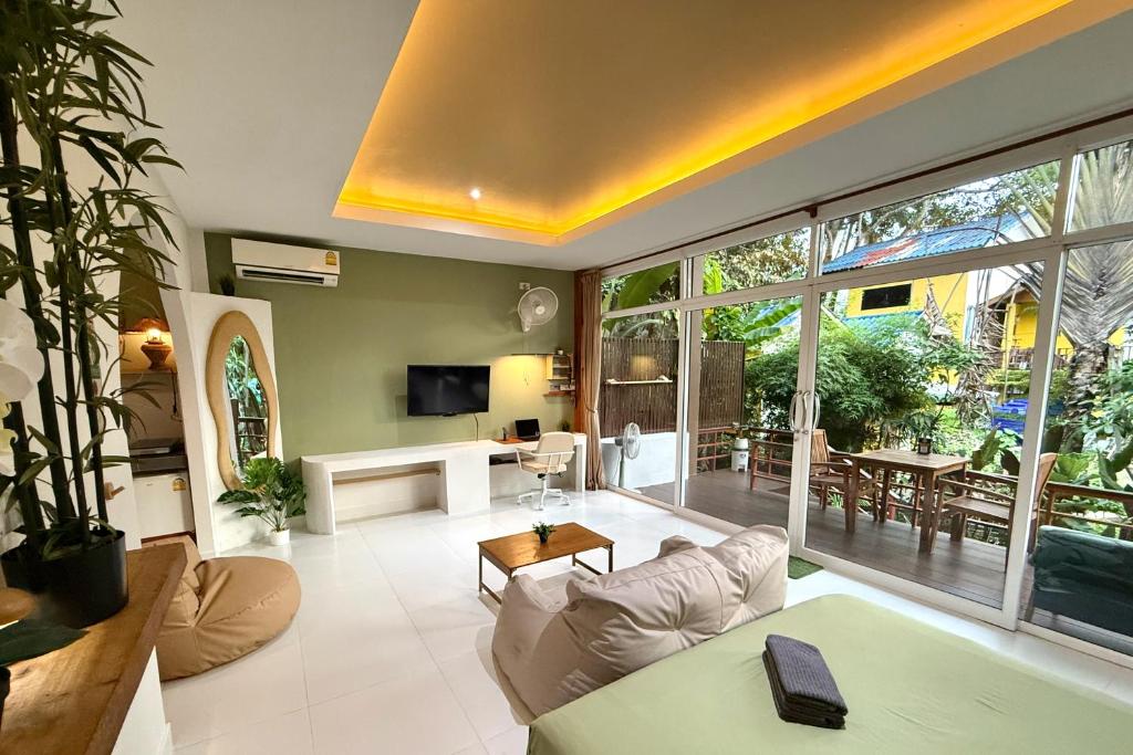 a living room with a couch and a table at Beach Jungle in Ko Chang
