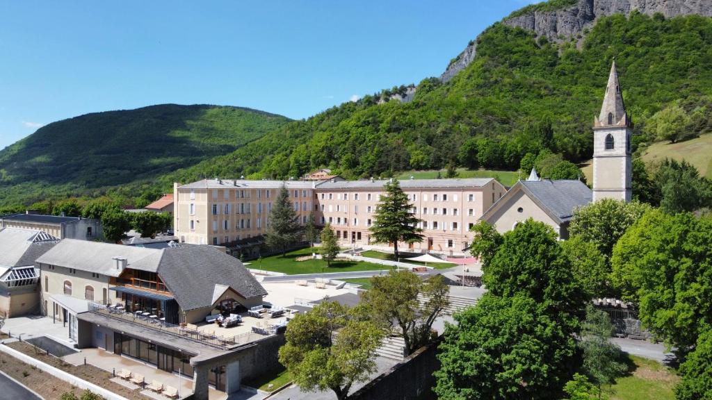 a small town with a church and a mountain at Notre Dame Du Laus in Saint-Étienne-le-Laus