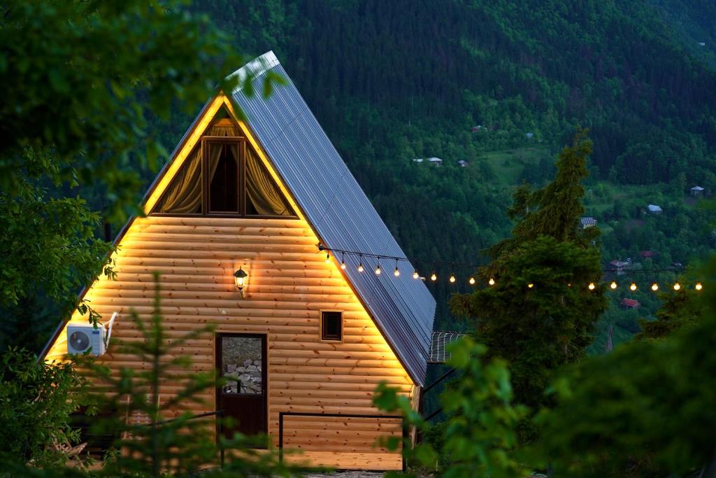 a small wooden church with a pointed roof at Shavsheti view Cottage in Didachara