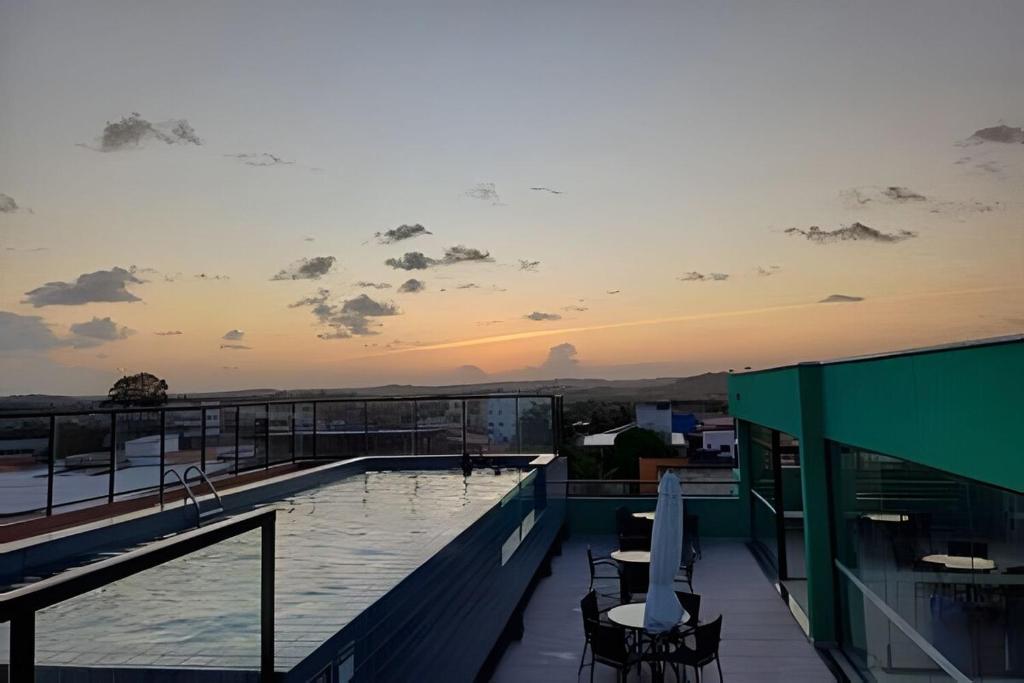 a swimming pool on the roof of a building at Flat no centro VDP314 - Rooftop in Porto De Galinhas
