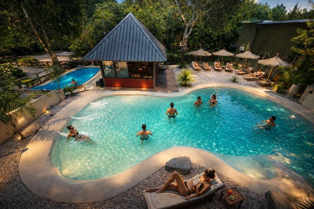 a group of people in a pool at a resort at Complejos Del Jaguel house in Santa Teresita