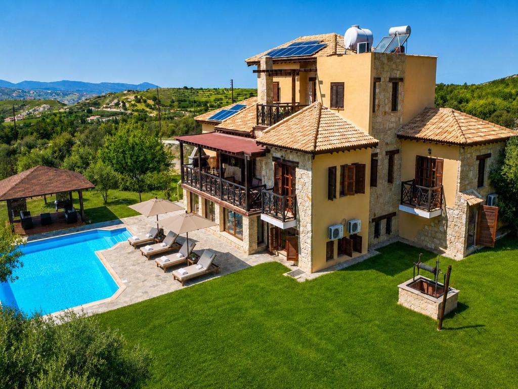 an aerial view of a house with a swimming pool at Villa River View in Peristerona