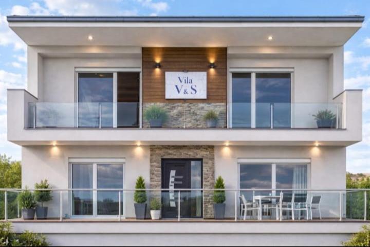 a large white sign on the side of a building at Vila V & S in Star Dojran