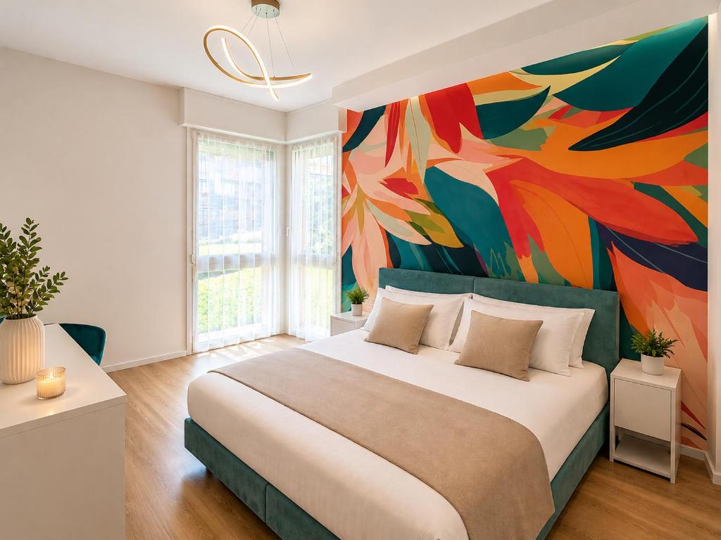 a bedroom with a large bed with a colorful wall at Sfreg Suites Magenta - Camere e B&B in Magenta