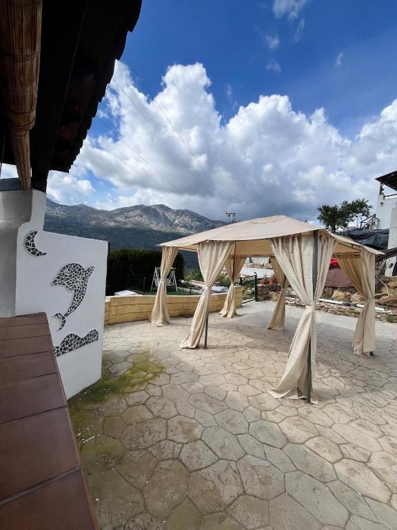 a tent set up on a patio with mountains in the background at Casa La Ferrata in Jimera de Líbar