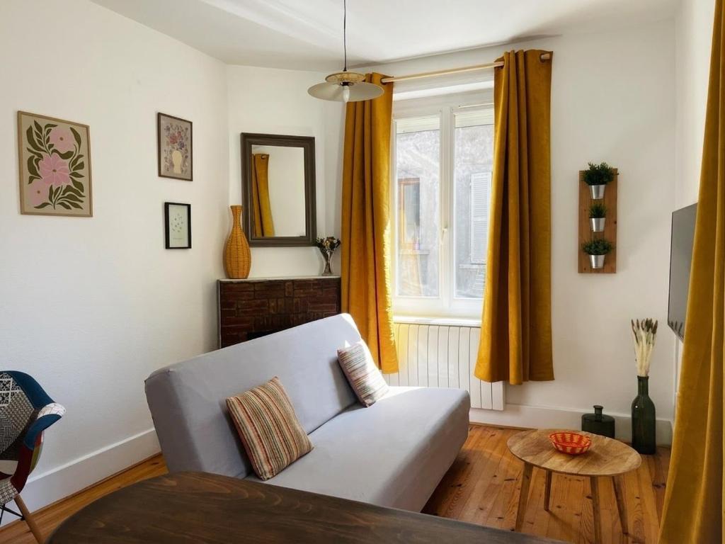 a living room with a couch and a window at La maisonnette 70' in Groseillier