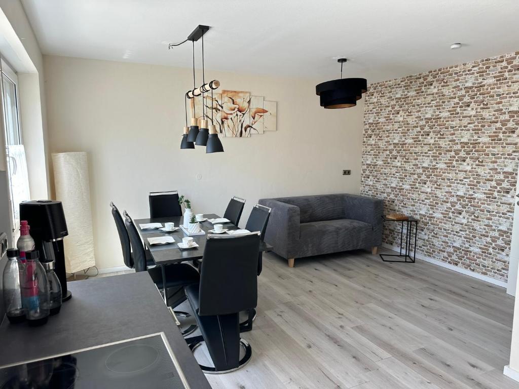 a living room with a table and a couch at Haselbach Living in Ehekirchen