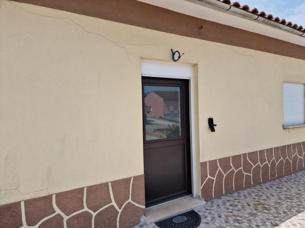 a door on the side of a building at 4 Seasons studio in Marinha das Ondas