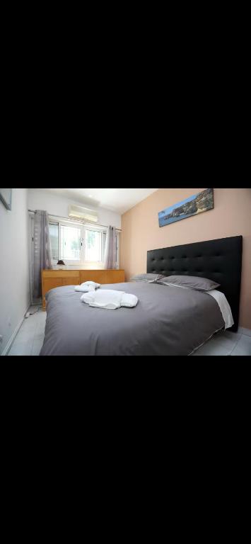 a bedroom with a bed with two towels on it at Dolls House in Lagos