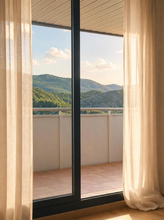 a room with a window with a view of the mountains at Refugio PIRENAICO in Sabiñánigo