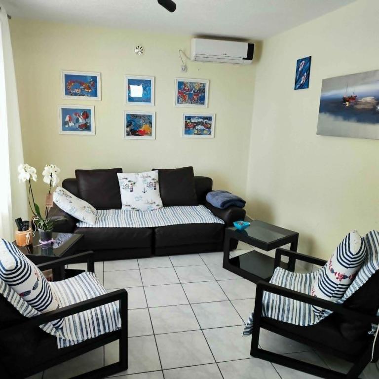 a living room with a couch and two chairs at Pine Tree House in Bar