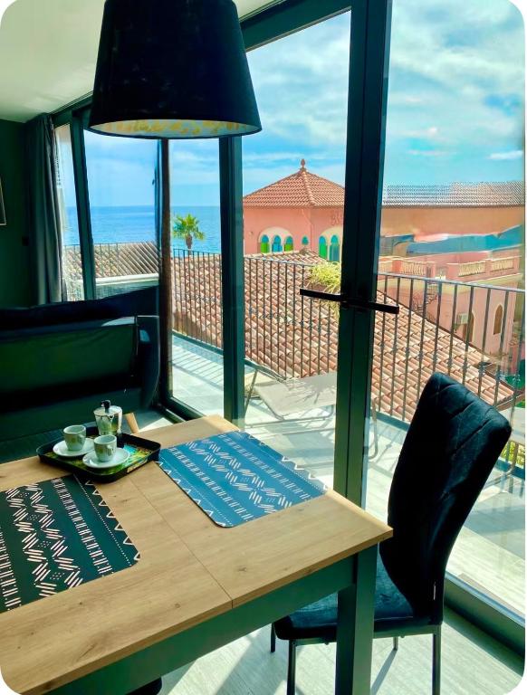a wooden table with a view of the ocean at Luxury Sofi in Giardini Naxos