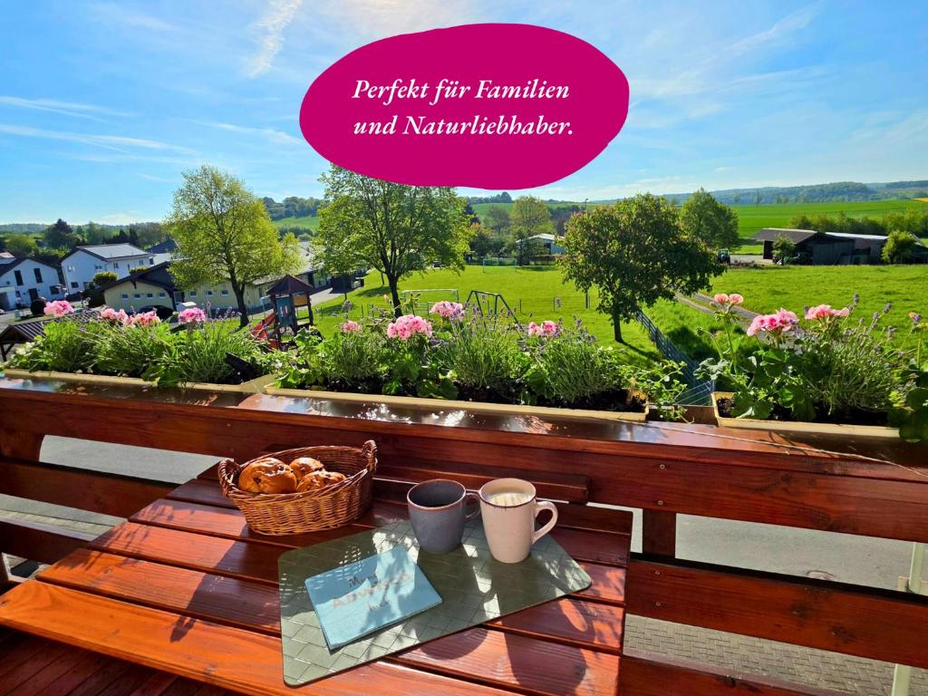 a wooden table with a basket of flowers on it at Ferienwohnung Matheaperle mit Infrarotkabine in Nidda