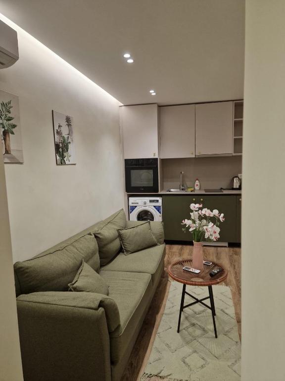 a living room with a couch and a table at Central Bazaar with Parking in Tirana