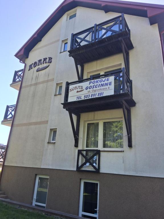 a building with a sign on the side of it at Ośrodek Korab in Władysławowo