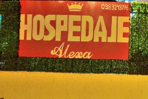 a red and white sign on a wall at Hospedaje Alexa in Asunción
