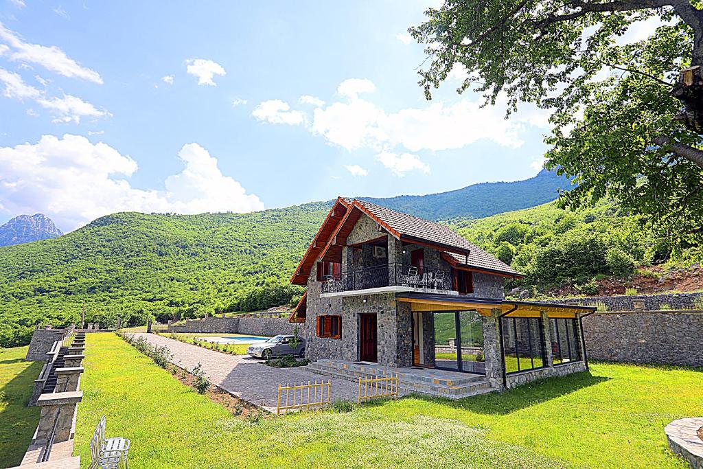 a small house in the middle of a field at Kulla e Andrrave in Ducaj