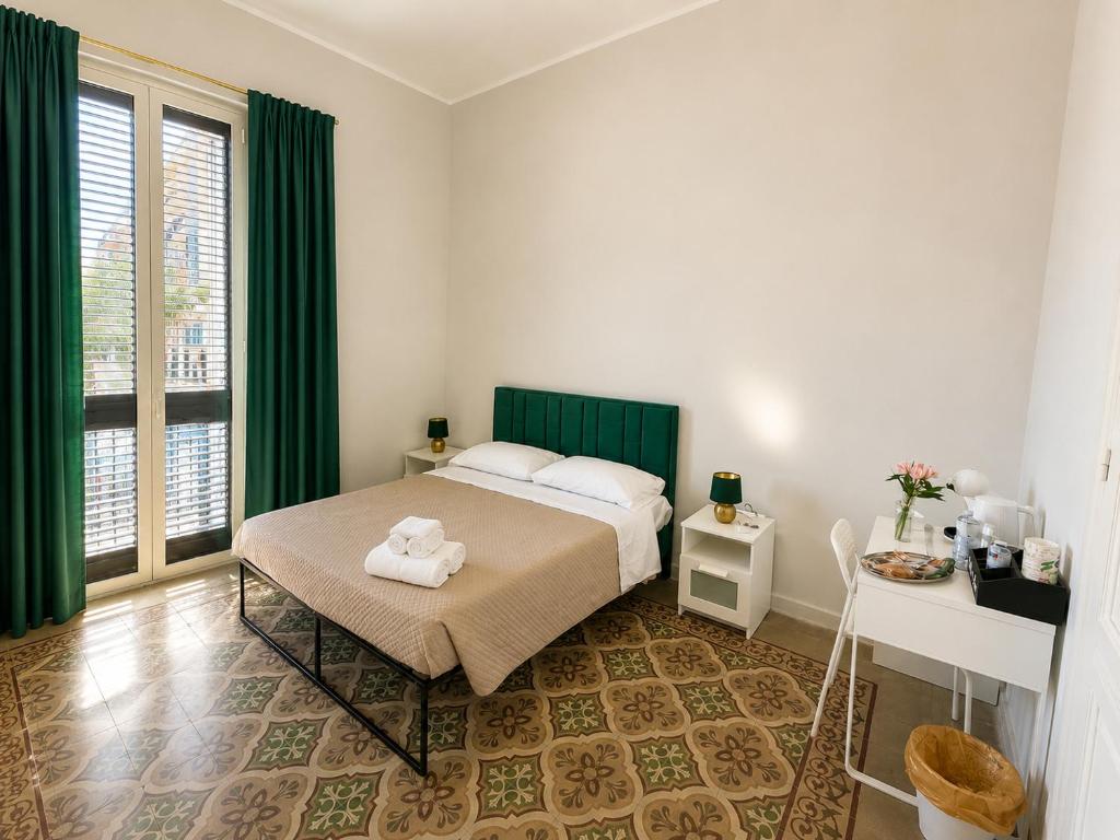 a bedroom with a bed with a towel on it at Alba Mediterranea in Reggio di Calabria