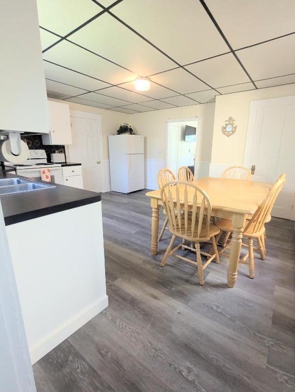a kitchen and dining room with a table and chairs at 1 central ave in Old Orchard Beach