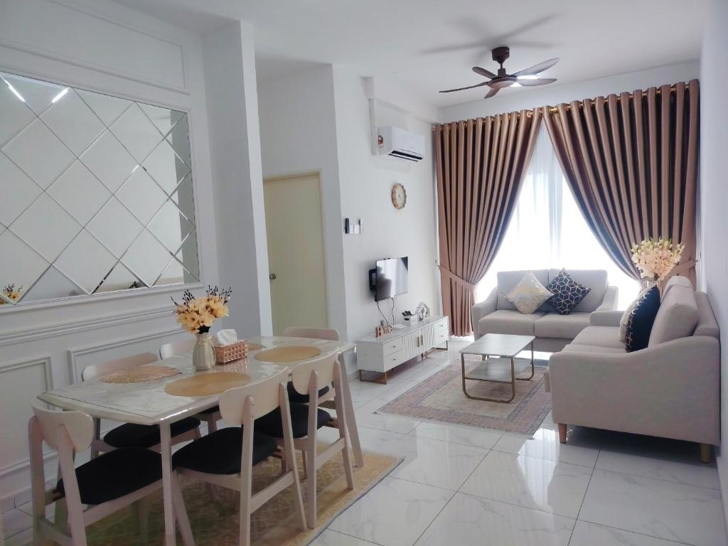 a living room with a table and a couch at Sky13 Homestay in Kota Bharu
