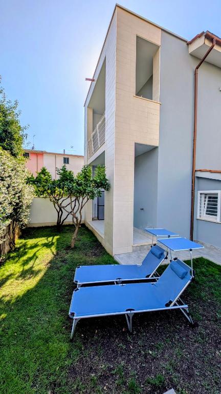 two blue ping pong tables in front of a building at Alloggio Turistico Francy House in Lido dei Pini