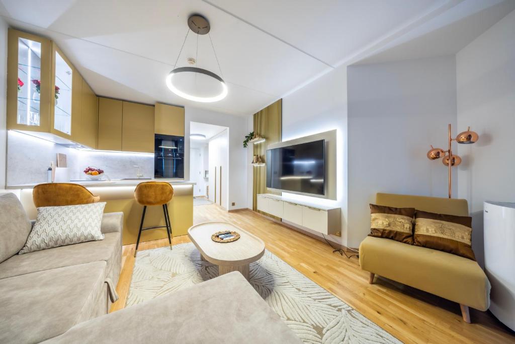 a living room with a couch and a table at Bright Studio in Rotermann Quarter - Noor Apartment in Tallinn