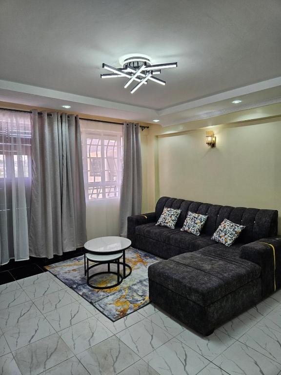 a living room with a couch and a table at Allan BnB HomaBay in Homa Bay