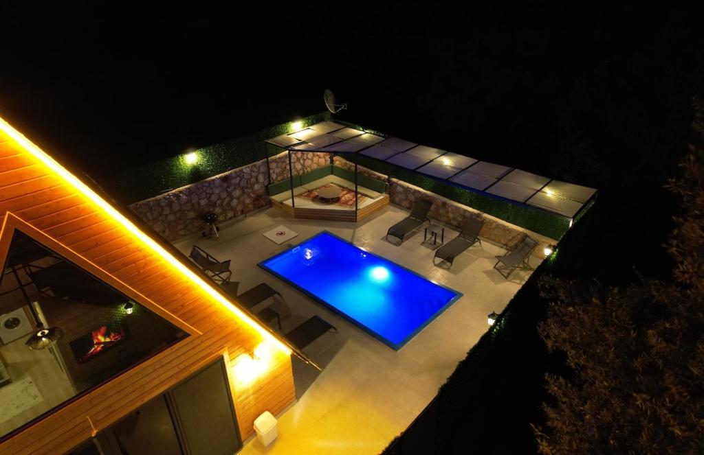 an overhead view of a swimming pool at night at Eylül Bungalow Kaş in Kaş