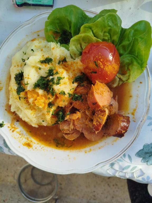 a plate of food with eggs and a tomato at WG-Zimmer in Frankfurt Oder